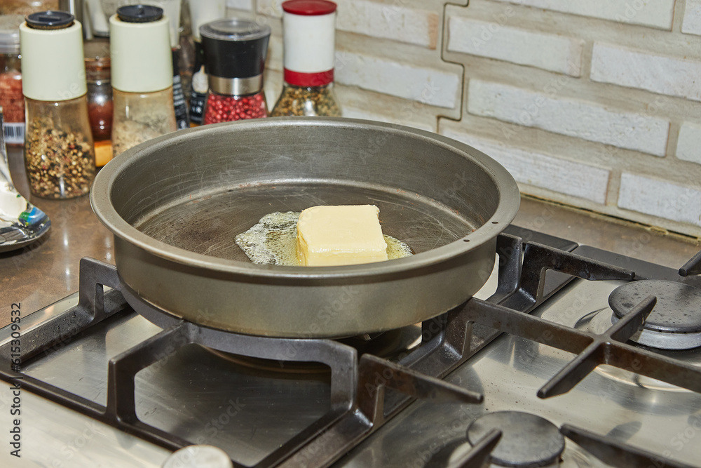 Butter is melted in frying pan over low heat