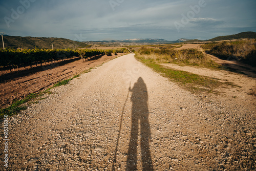 Leinwand Poster NAVARRE, SPAIN - OCTOBER 2022 pilgrim walking in French Way Camino Frances to Sa