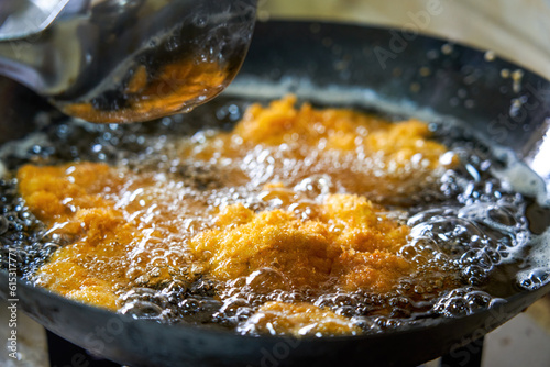 Delicious chicken chops are being fried in the kitchen oil pan