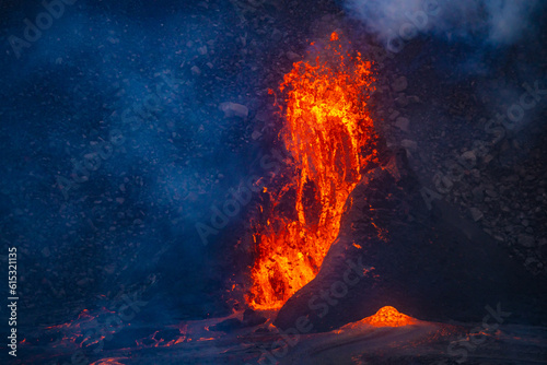 Lava erupting. Night view of Halemaʻumaʻu from Kilauea Overlook June 2023. Kīlauea Caldera. Hawaiʻi Volcanoes National Park.