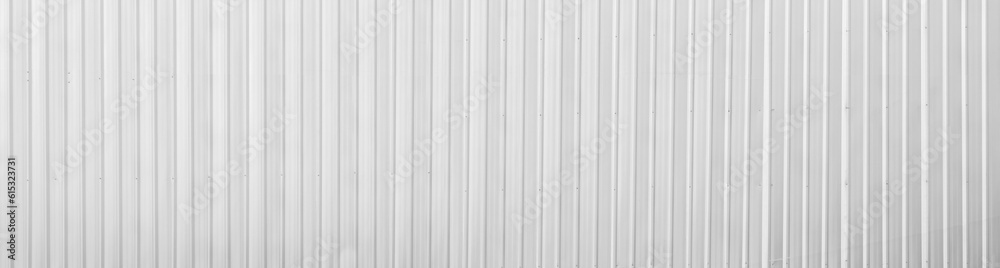 Fototapeta premium Wide metal aluminum silver corrugated stripe sheet wall background with texture vertical lines