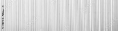 Wide metal aluminum silver corrugated stripe sheet wall background with texture vertical lines