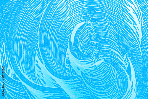 soap foam in circle waves,sky blue window glass background