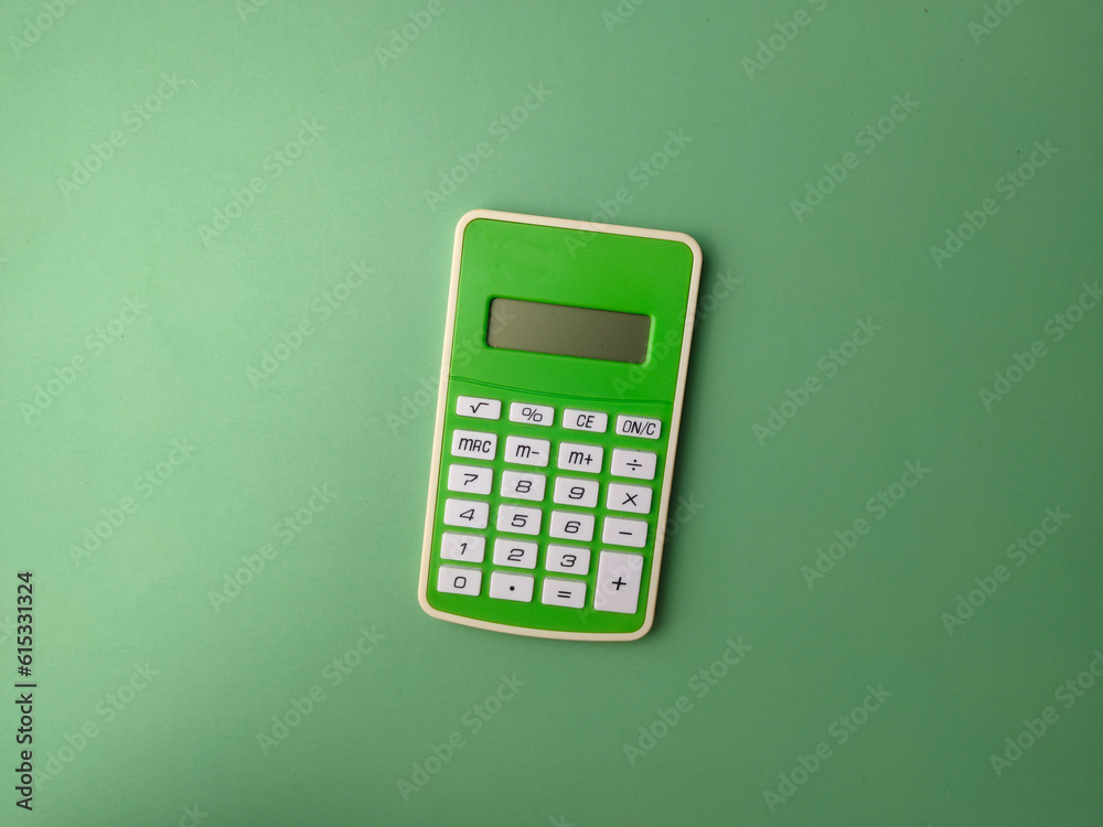 Top view green calculator on a green background Top view green calculator on a green background