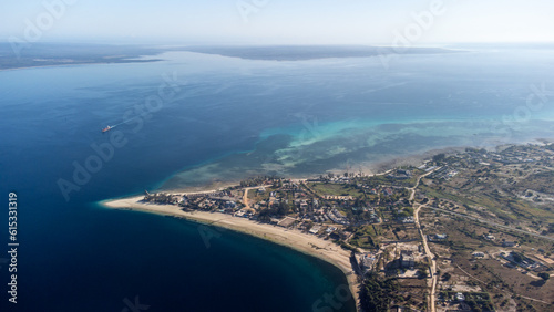 Aerial view of seaside town with blue waters and sandy beaches