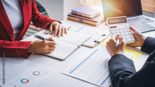 Close up hand young businesswoman calculating  working on desk office with the chart graph financial account