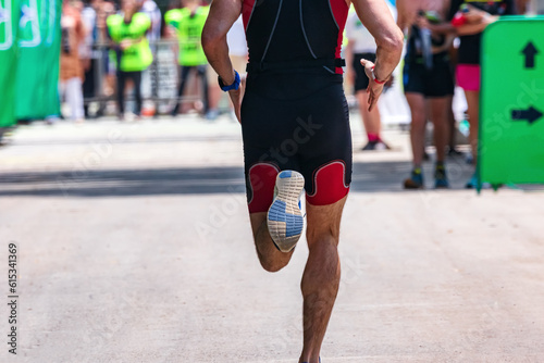 The legs of an athlete running on the asphalt marathon distance