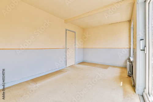 an empty room with white walls and blue paint on the walls, there is a window in the corner that looks out to the