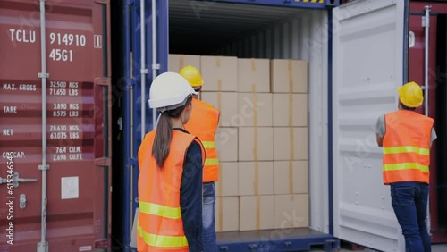 Manager engineer woman control work via Walkie talkie while foreman and a worker help opening containers together at the transport warehouse. Cargo container and Transport Logistic concept
