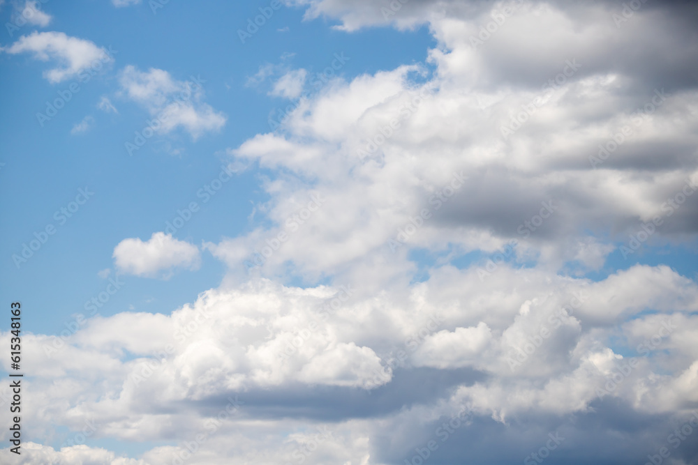 White cumulus clouds against the blue sky