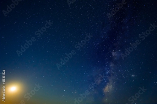 night starry sky with milky way and rising moon