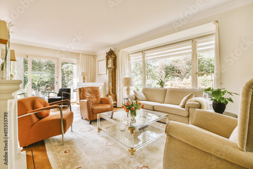 a living room with couches, chairs and a coffee table in the center of the room is large windows