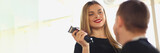 Smiling female hairdresser holding hair trimmer and communicating with male client. Choosing stylish fashionable hairstyle for man