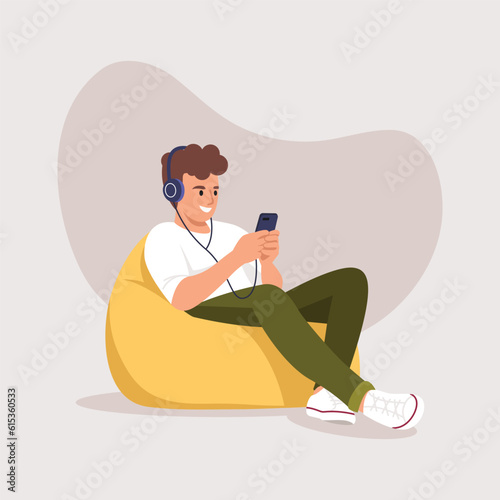 boy in headphones sitting on a bag chair