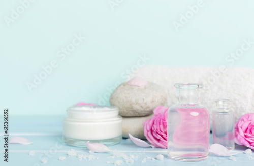 Spa composition with pink roses on wooden table