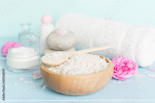 Spa composition with pink roses on wooden table