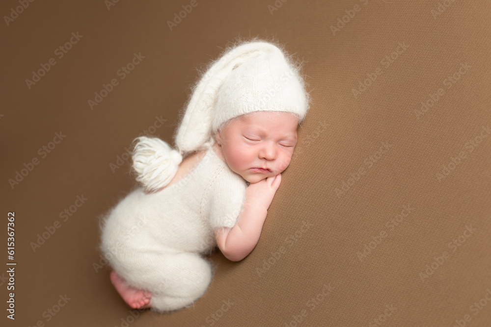Little charming newborn baby boy sleeps on his stomach. Neutral background. Studio shot of a newborn. Beginning of life. Little charming newborn baby boy sleeps on his stomach. Neutral background. Studio shot of a newborn. Beginning of life.