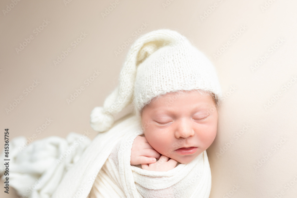 portrait of a small charming newborn boy on a light background. hat cap on the child. Studio shot of a newborn. portrait of a small charming newborn boy on a light background. hat cap on the child. Studio shot of a newborn.