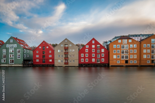 Long exposure of colorful historic timber storehouses in Trondheim, Norway in winter