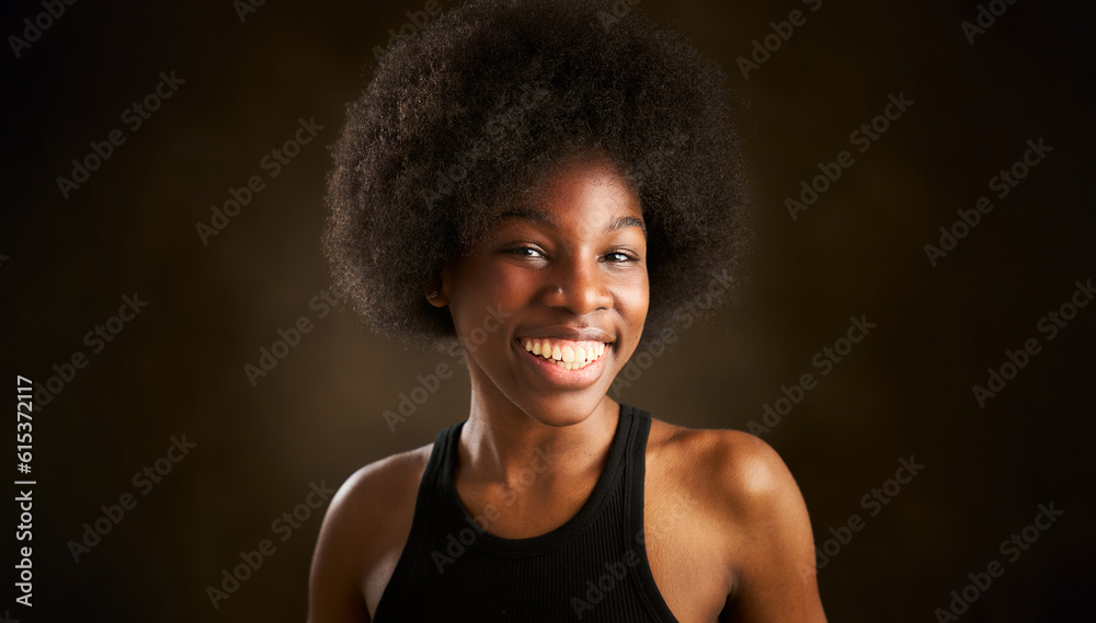 Portrait of cheerful young African American woman in black t-shirt with afro hairstyle smiling and looking at the camera Portrait of cheerful young African American woman in black t-shirt with afro hairstyle smiling and looking at the camera