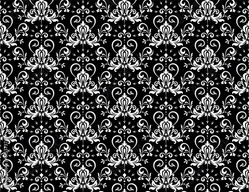 Wallpaper in the style of Baroque. Seamless vector background. White and black floral ornament. Graphic pattern for fabric, wallpaper, packaging. Ornate Damask flower ornament
