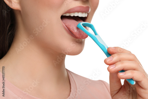 Fotografie Woman brushing her tongue with cleaner on white background, closeup