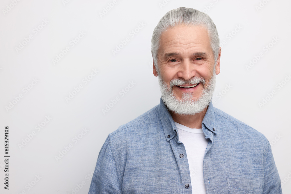 Obraz premium Portrait of handsome senior man on white background. Space for text