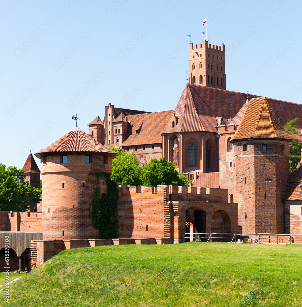 View of brick Gothic Castle of Teutonic Knights located in ancient Polish town of Malbork.