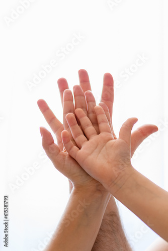 Family hands with child at isolated background