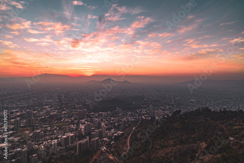 pink and orange sunset view over city of Santiago de chile from mountain San Cristobal