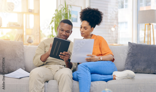 Tablet,documents, smile and couple on sofa in home living room, bonding and online shopping. Interracial, technology and happy black man and woman relax on social media, internet browsing or web scro