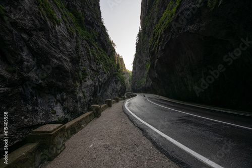 Amazing curved road between the mountains. Wide angle landscape photo with the road from Bicaz Gorges (Cheile Bicazului in Romanian language) landmark in Transylvania and Moldova.
