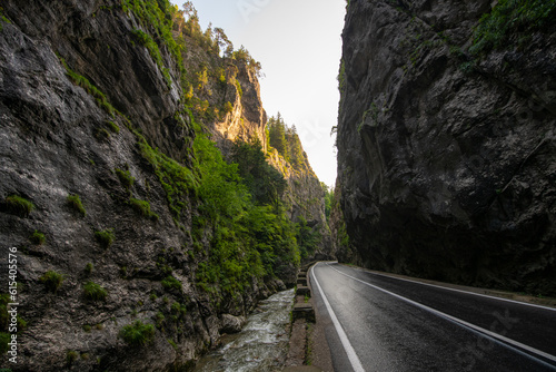 Amazing curved road between the mountains. Wide angle landscape photo with the road from Bicaz Gorges (Cheile Bicazului in Romanian language) landmark in Transylvania and Moldova. photo