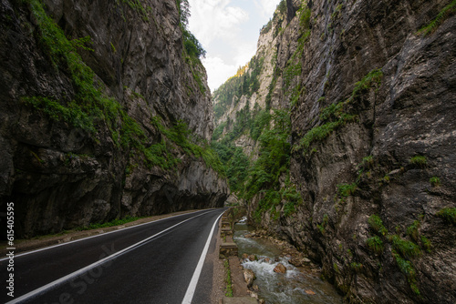 Amazing curved road between the mountains. Wide angle landscape photo with the road from Bicaz Gorges (Cheile Bicazului in Romanian language) landmark in Transylvania and Moldova. photo