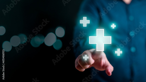 Businessman touching digital plus sign as positive thinking and benefit mindset or healthcare medical hospital welfare symbol and health insurance on dark background. Additional and advantage concept.