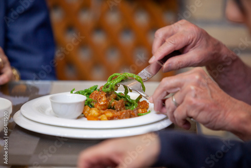 a man eating salad from plate