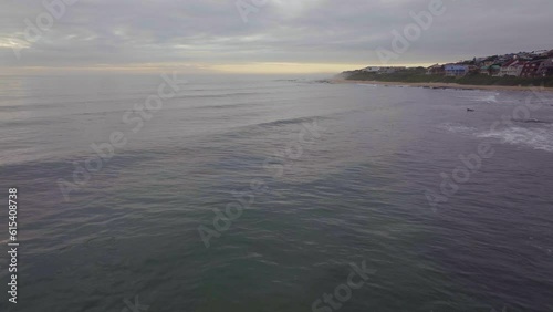 South Africa drone aerial Jeffreys Bay surf town stunning early morning sunrise golden sun on ocean surfer wave groundswell Sunrise sunset drone JBay stunning coastline beach cinematic forward motion photo