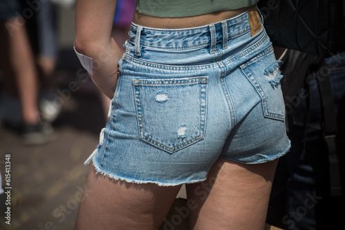 Closeup of mini jeans short on woman in the street