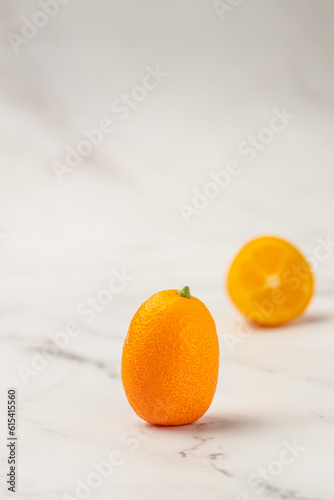 Raw Organic Orange Kumquats, vertical image. top view. place for text photo