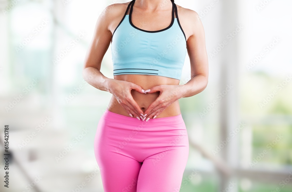 Young female holds her tummy in hands