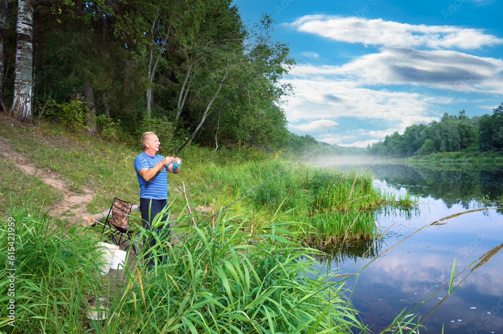 In the early summer morning, a fisherman is fishing in the upper reaches of the Volga River.