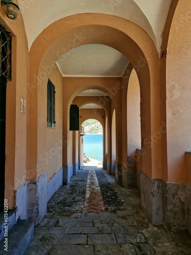 Portico in Levanto on the coast of Ligurian sea, with blue water in the background © LE-gals Photography