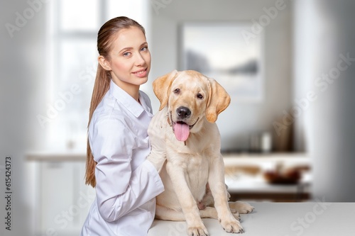 Young beautiful woman veterinarian hugging dog