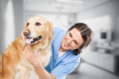 Young beautiful man veterinarian hugging dog