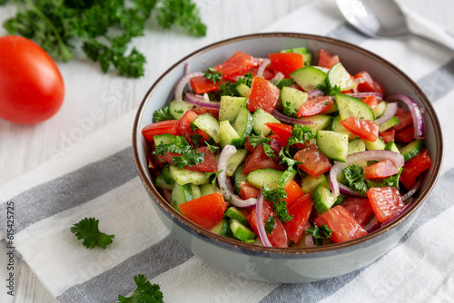 Homemade Mediterranean Cucumber Tomato Salad in a Bowl, side view.