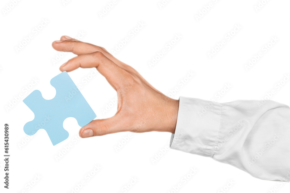 Businessman Hand Holding a Puzzle Piece Businessman Hand Holding a Puzzle Piece