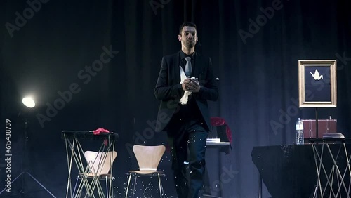 Magician making a dove appear in a magic trick. Slow motion shot.
