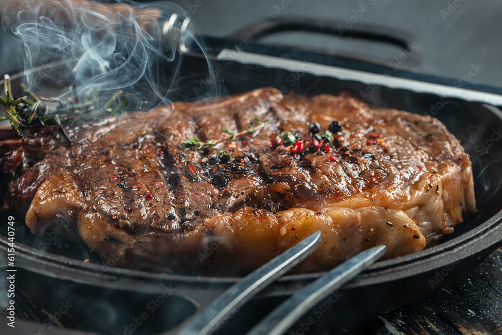 beef grill steak with smoke. The concept of cooking meat, Food recipe background. Close up