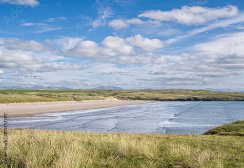 The Beach at Aberffraw.  The beautiful beach at Aberffraw in Anglesey.  The tide is slowly rolling in on this glorious day.  In the background is the Sowndonia mountain range.