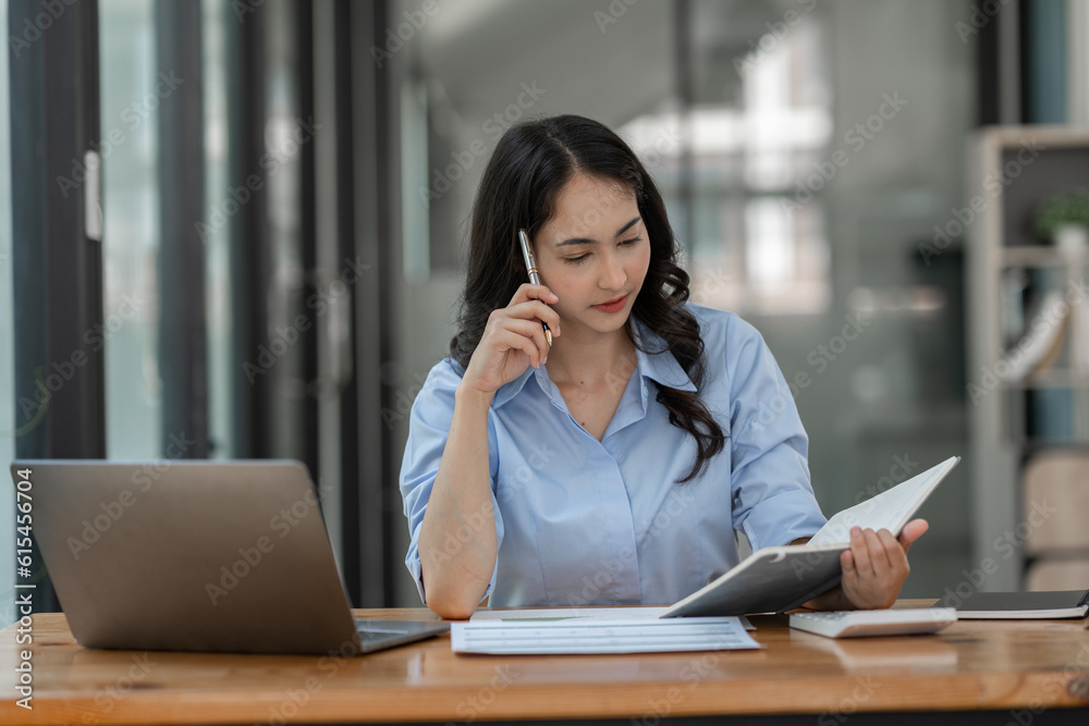 Businesswoman working using laptop to search for information Take note of the details. about financial investments Real estate business Document work to analyze the plan management system concept Businesswoman working using laptop to search for information Take note of the details. about financial investments Real estate business Document work to analyze the plan management system concept